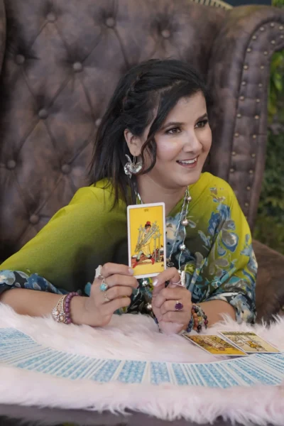 Ruhii Rai smiling while presenting tarot card during a marriage numerology session in Bhopal.