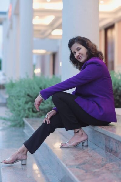 Ruhii Rai – Professional Numerologist in Bhopal sitting confidently in a formal purple blazer